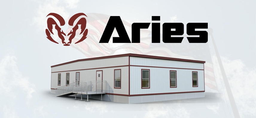 A white with red outline temporary building, with plenty of windows and a wheelchair-accessibility ramp. Above the structure is the word Aries, with the ram logo to the left. 