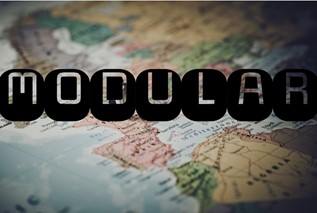 A world map with the words, “MODULAR” in the foreground. The shading around the right edge of the image is darkened, giving an interesting artistic feel to the picture.