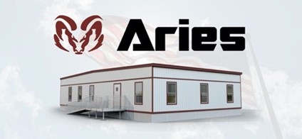 A square Aries’ modular building, white with burgundy trim, and equipped with a ramp for accessibility. Above it, in black text, “Aries” is written in a bold, black font, next which is the maroon, Aries’ ram logo. In the background is a translucent American flag flying against a cloud-filled sky.
