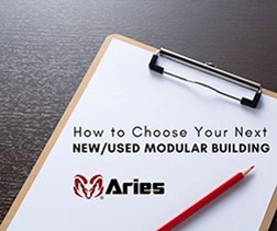 An image of a clipboard slanted to the right on a dark wooden table with a red pencil sitting on top. A piece of paper that has text that reads, “How to Choose Your Next New/Used Modular Building” and the Aries’ logo written in black with a ram in dark red to the left of the text.