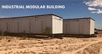 A photograph of two modular building under a blue sky. The modular buildings are resting on a grassless field. The phrase, “INDUSTRIAL MODULAR BUILDING” is in white text on the upper left.
