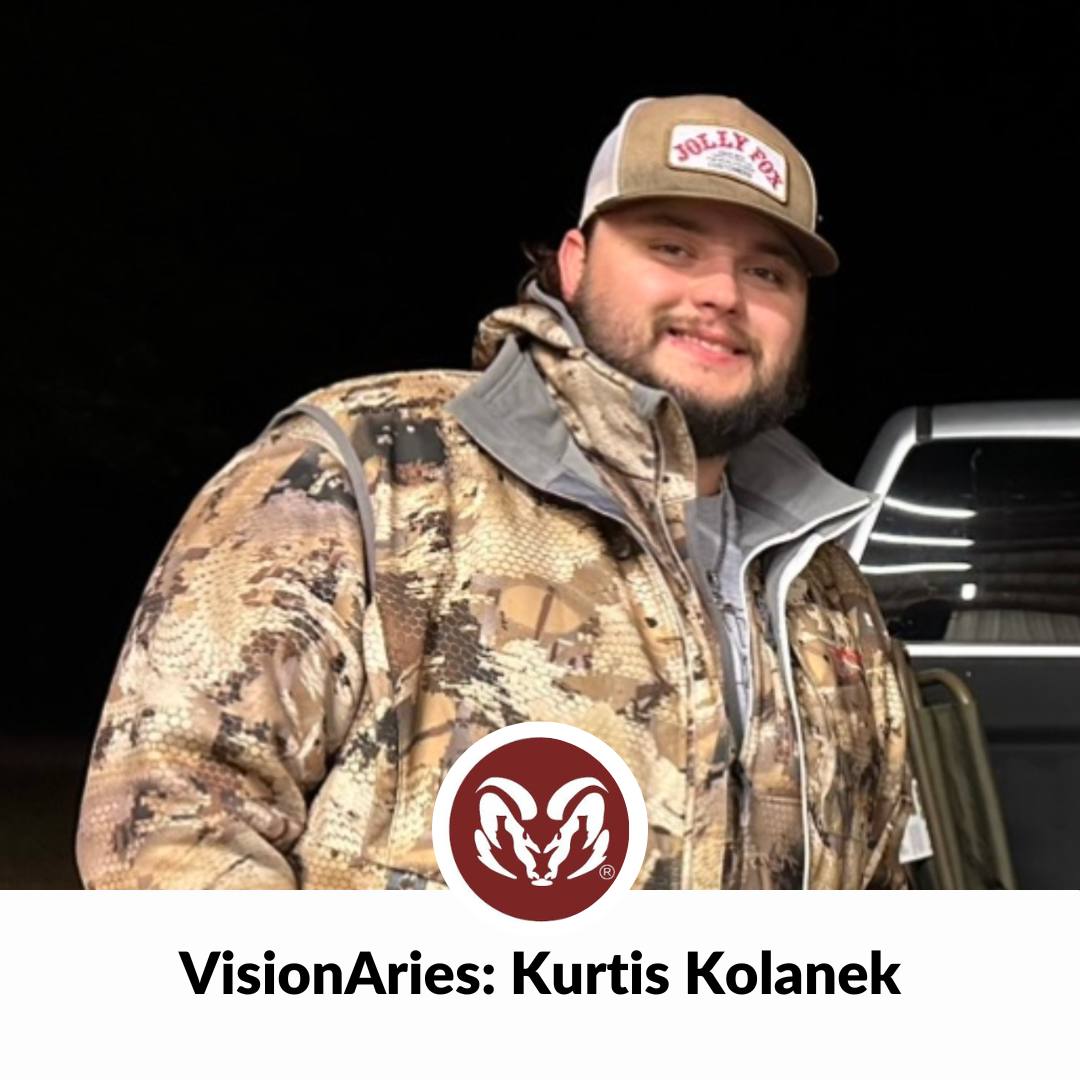 Aries_VisionAries Kurtis Kolanek, a man with a beard wearing a baseball cap and a camo jacket