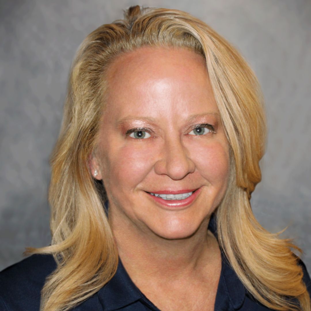 Headshot of Julee Griffin, Sales Associate for Aries Buildings. She has wavy blonde hair and a collared black shirt on.