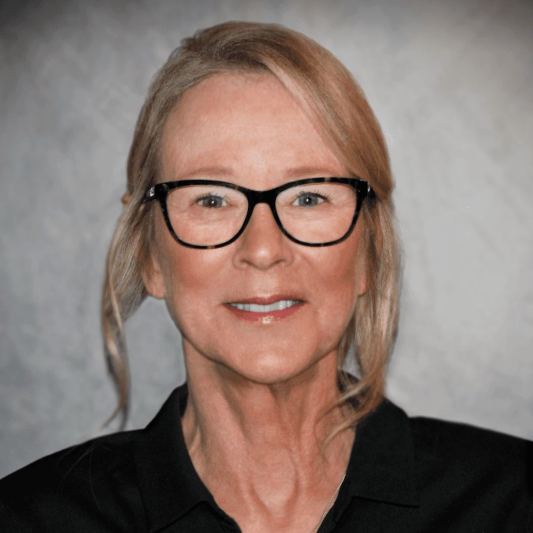 Headshot of Rebecca Mayer, Sales Associate for aries Buildings in Centennial, CO. She has her hair pulled back with glasses on and is wearing a black collared shirt.