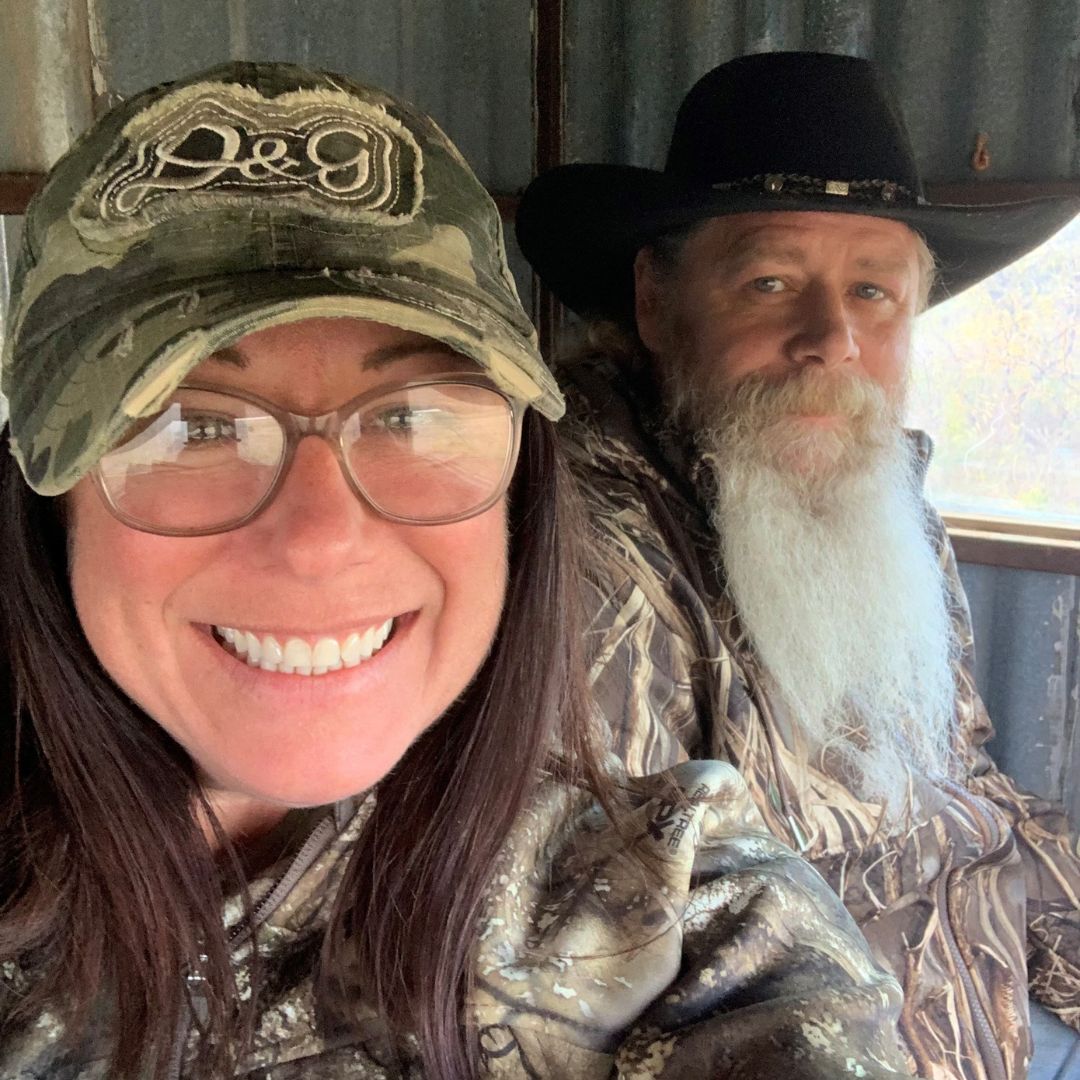 A selfie of Stacey smiling with her husband.