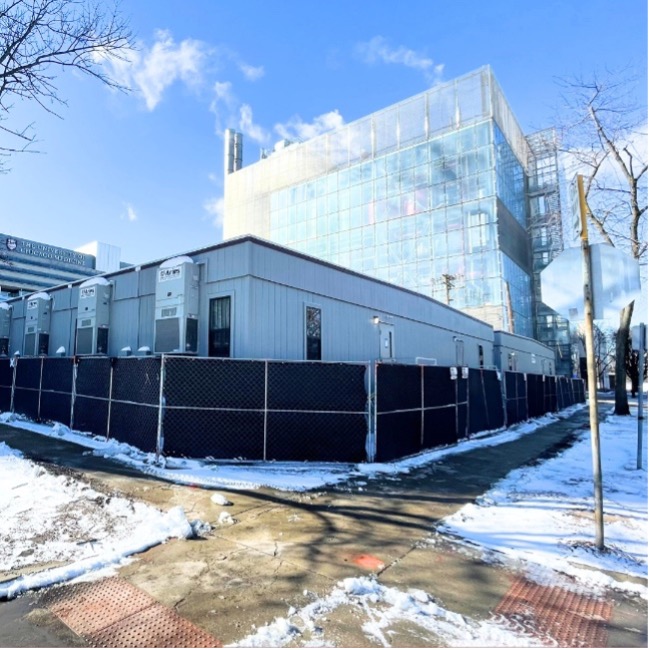 Exterior shot of several Aries’ modular office buildings in the snow with a privacy fence and walkways that have been cleared of the snow.