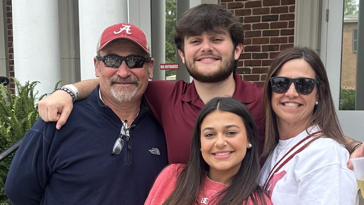 Photo of Lonn Elzey smiling with his family, including his wife, son, and daughter.