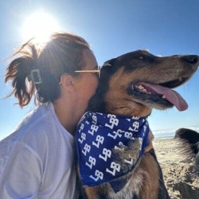 Lani Baze hugging her dog Bo at the beach.