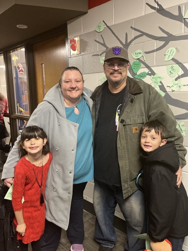 VisionAries Spotlight, Heather Irwin, posing with her husband, Shaun, and their two grandchildren.