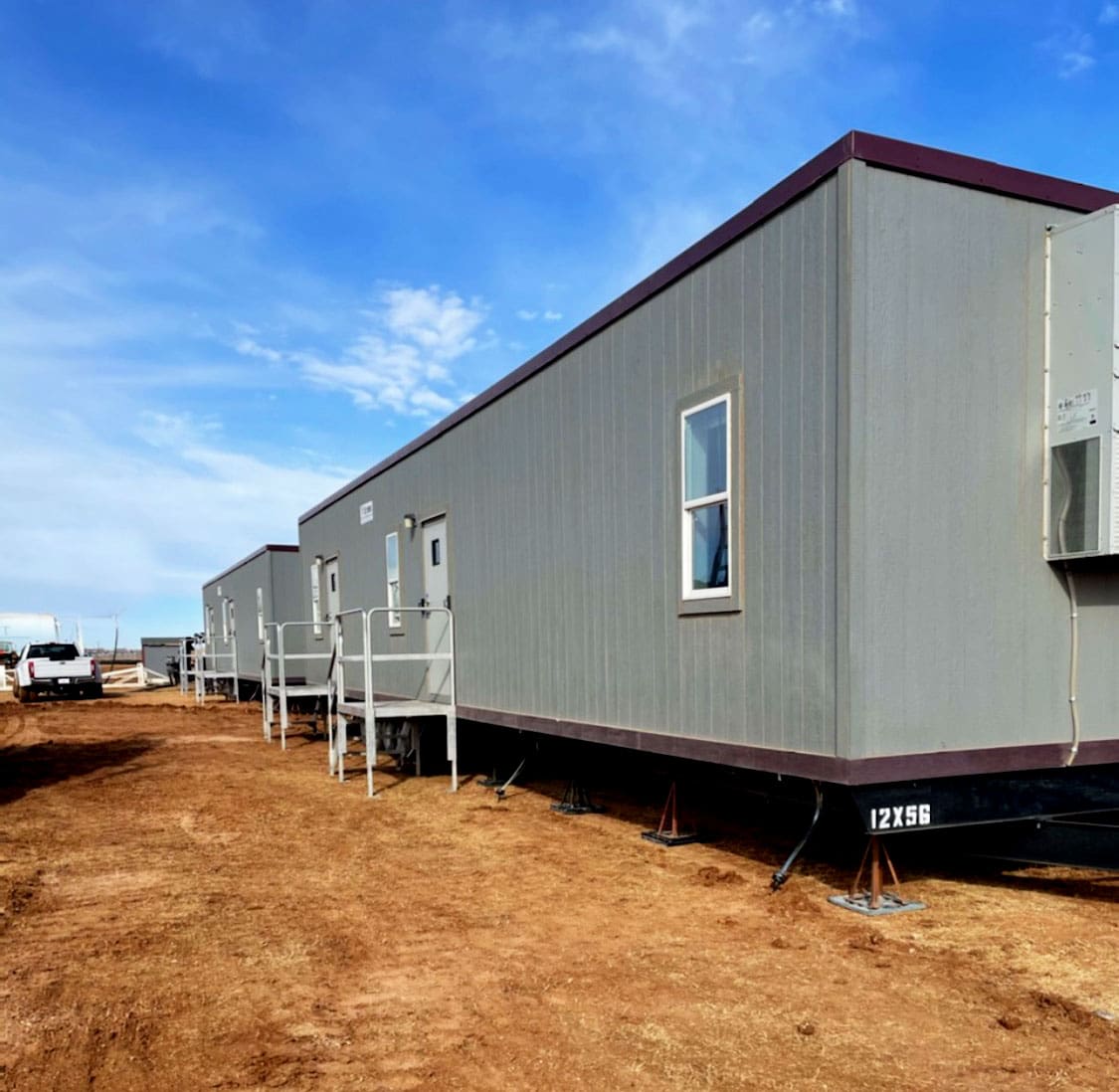 Row of Aries modular mobile offices installed on a remote oil, gas, and energy project site.