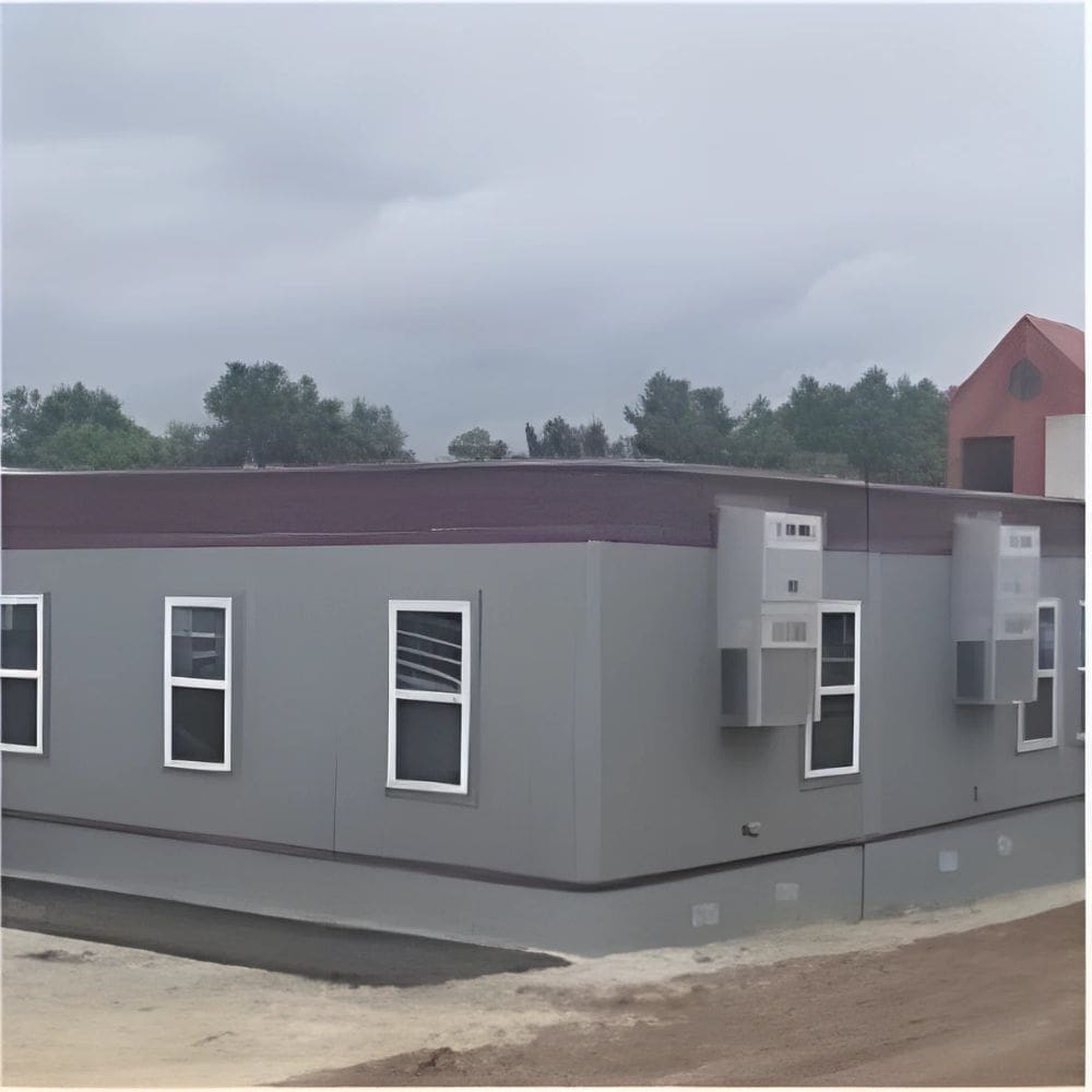 Close-up view of Aries GSA mobile office units with external HVAC systems, wooden staircases, and safety barriers set up in the lot.