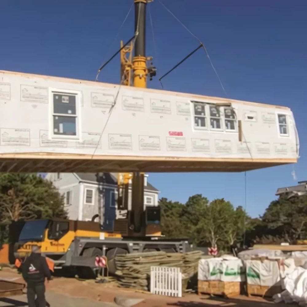 A row of GSA mobile office units with wooden staircases and orange and white safety barriers in the parking lot, equipped with external air conditioning systems.