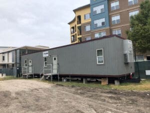Temporary modular office buildings by Aries installed at an urban corporate job site for business expansion.