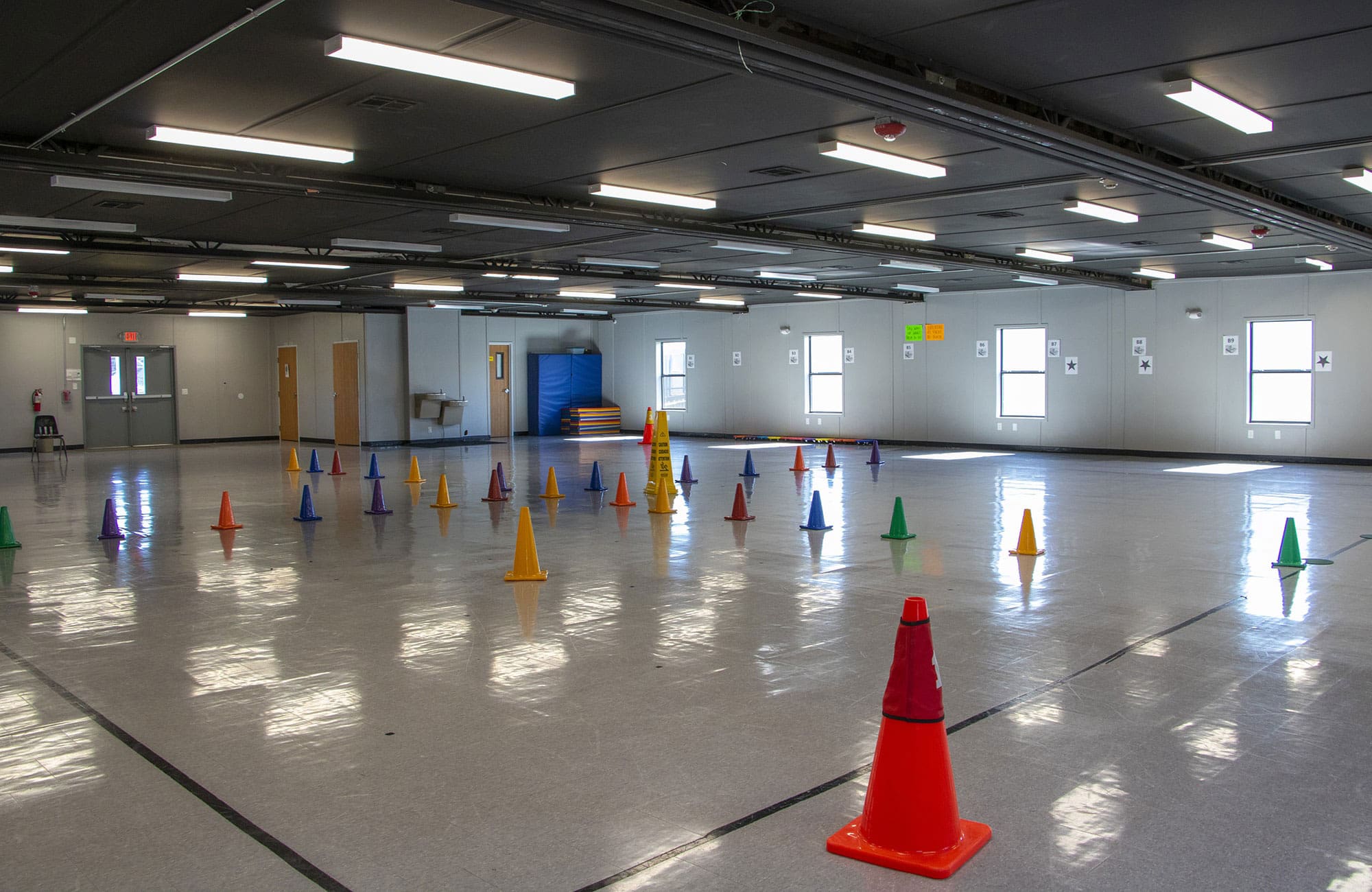 Interior of an Aries modular building gymnasium set up with training cones for hands-on learning activities.