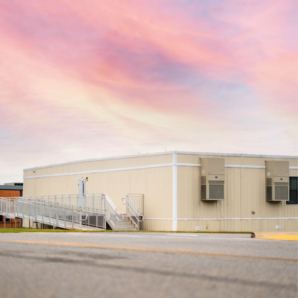 An exterior shot of one of Aries' modular buildings with a beautiful sunset in the background.