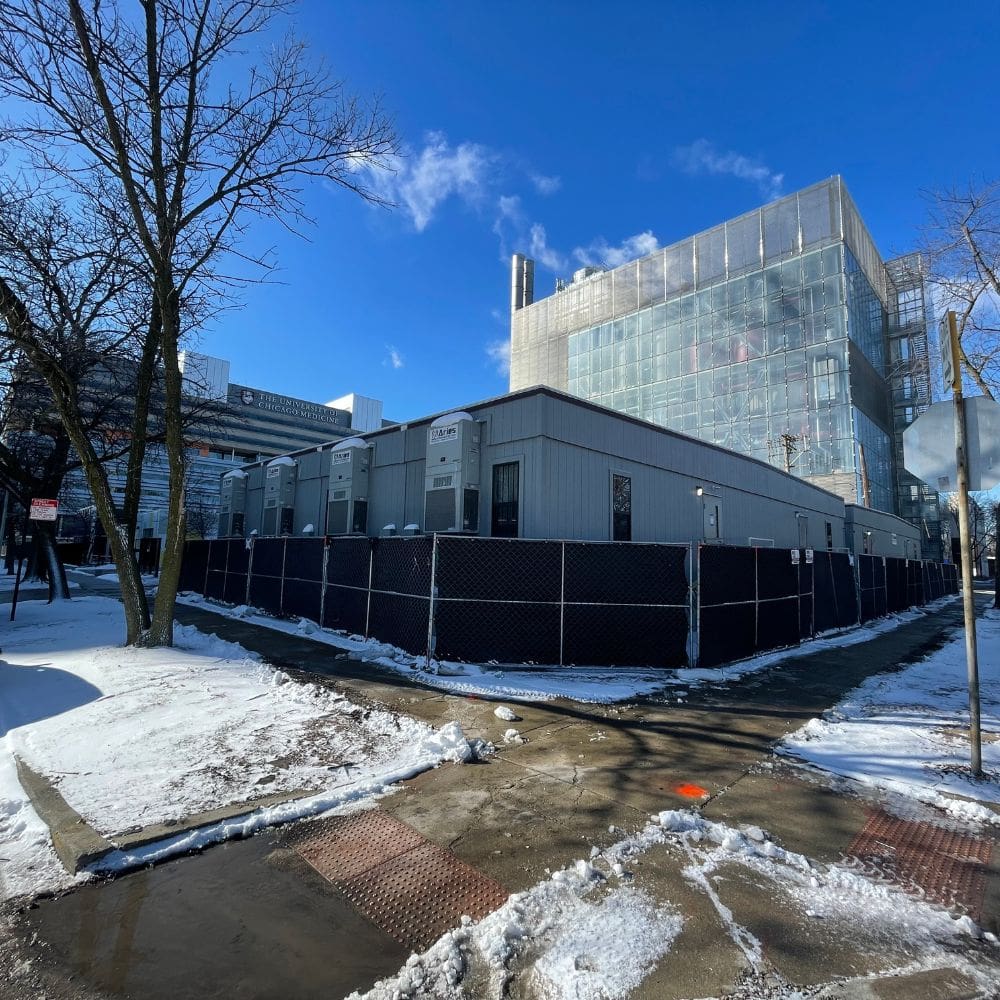 A snowy landscape with a large modular facility by Aries Buildings.