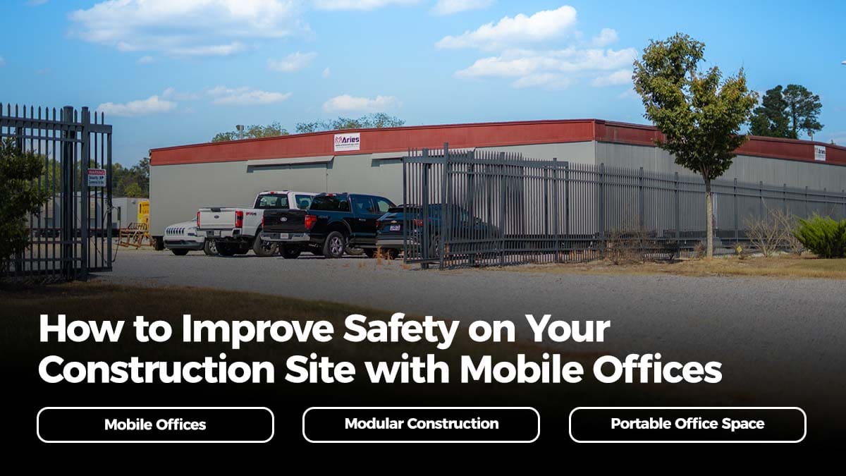 Mobile offices for construction safety at a secure Aries jobsite, with trailers, fencing, and pickup trucks on-site.