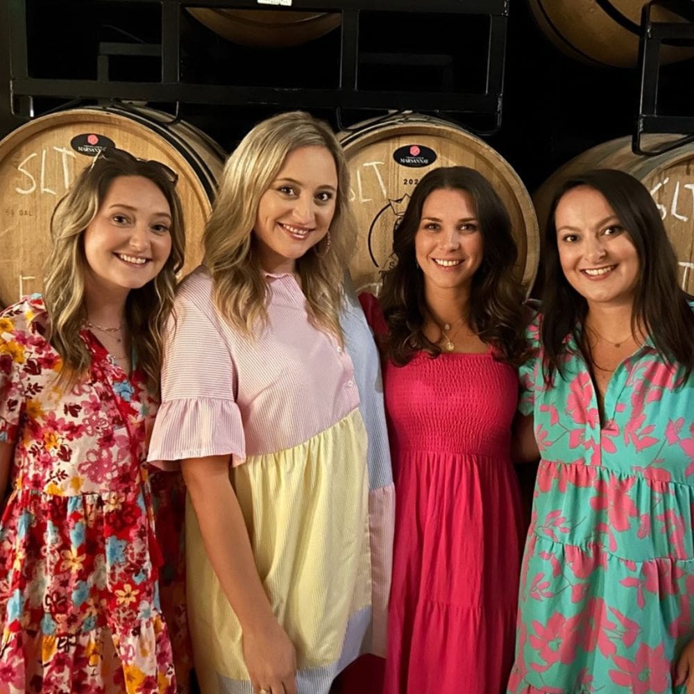 A photo of VisionAries Spotlight, Bailey Beck, smiling with friends at a distillery.