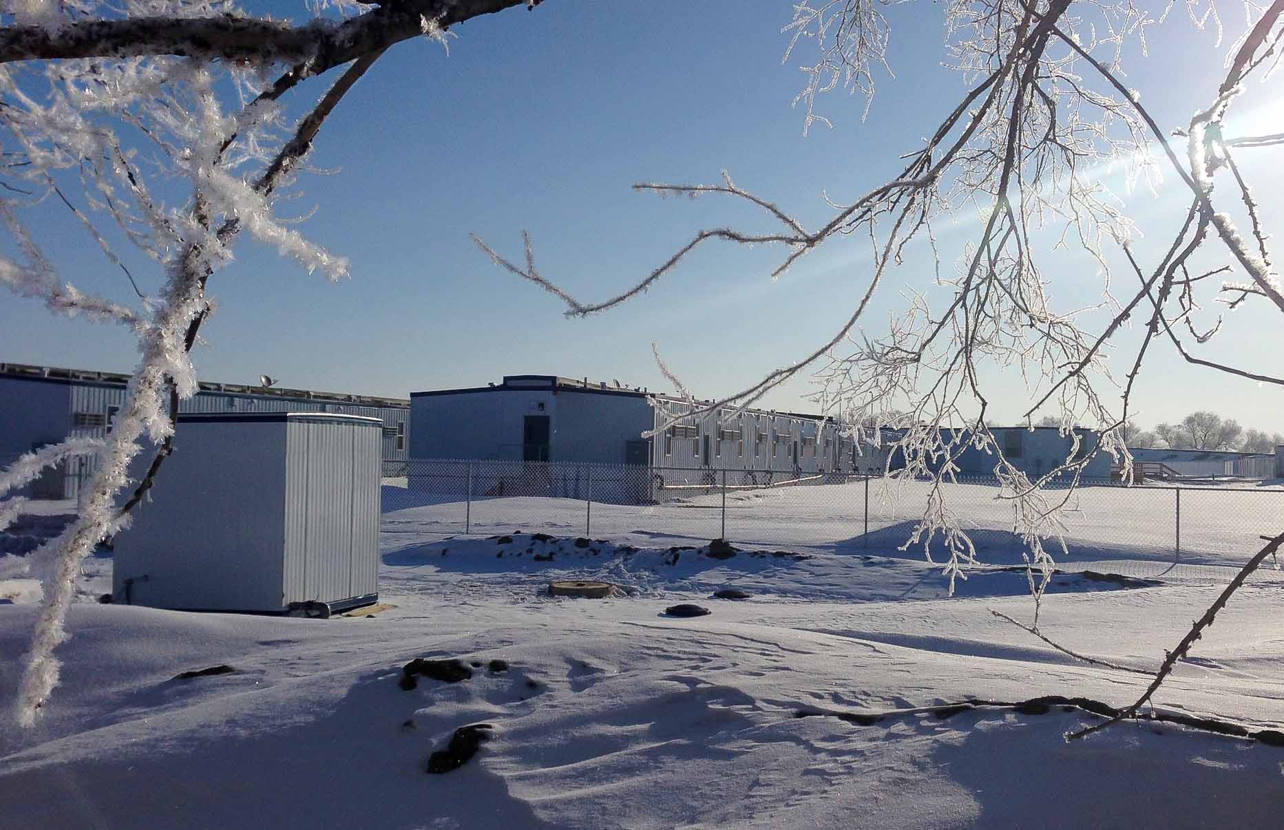A row of modular buildings after a snowfall.