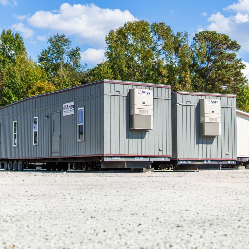 Exterior shot of a couple ready-to-go mobile offices showcased in Aries’ modular building stock yard in Clayton, NC.