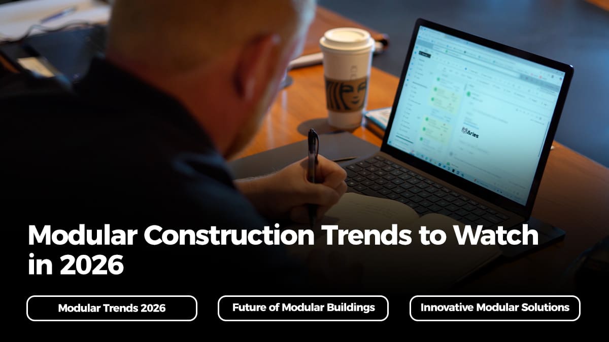 Professional reviewing data and notes on modular construction trends 2026 with Aries email open on screen.