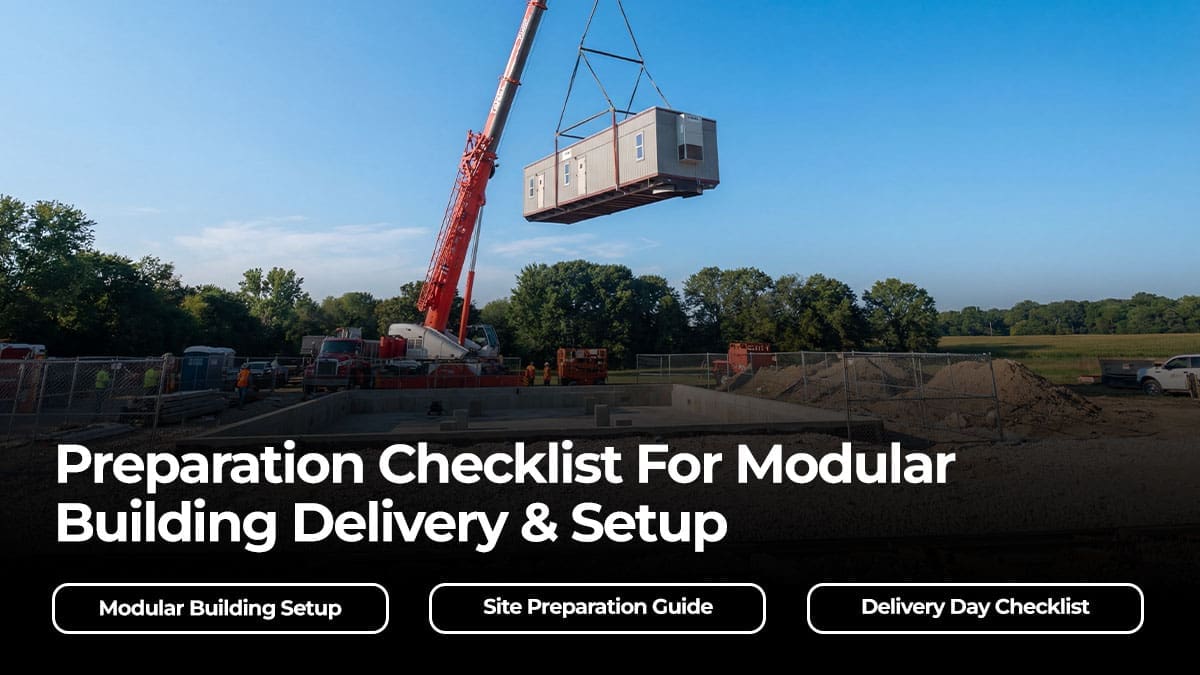 Modular building being craned into place at a construction site, with crew and equipment on-site for setup.