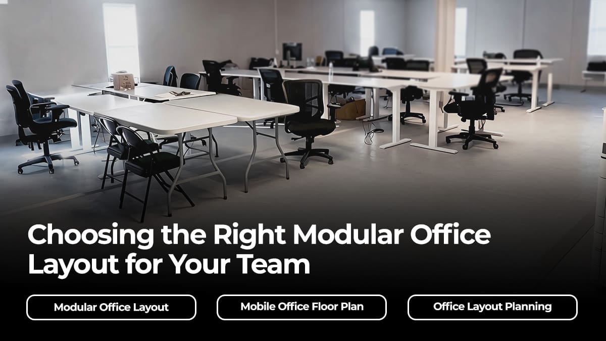 Interior of a modular office setup with rows of desks and office chairs arranged for team collaboration